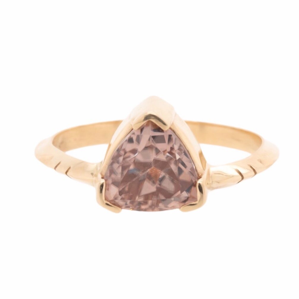 Umbra Trillion Ring featuring a dusty rose-colored Australian zircon wrapped in yellow gold.